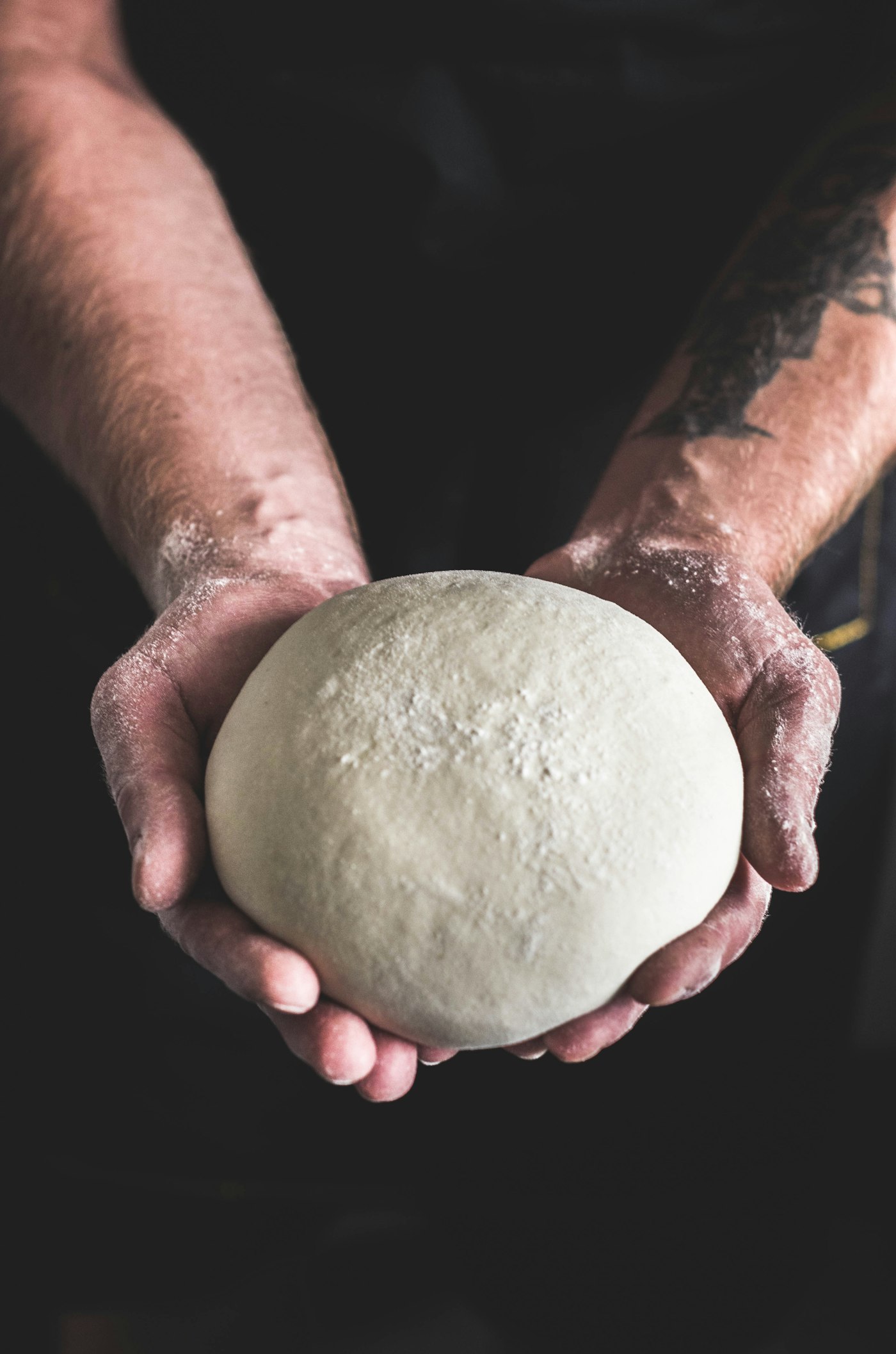 Hands holding a ball of dough