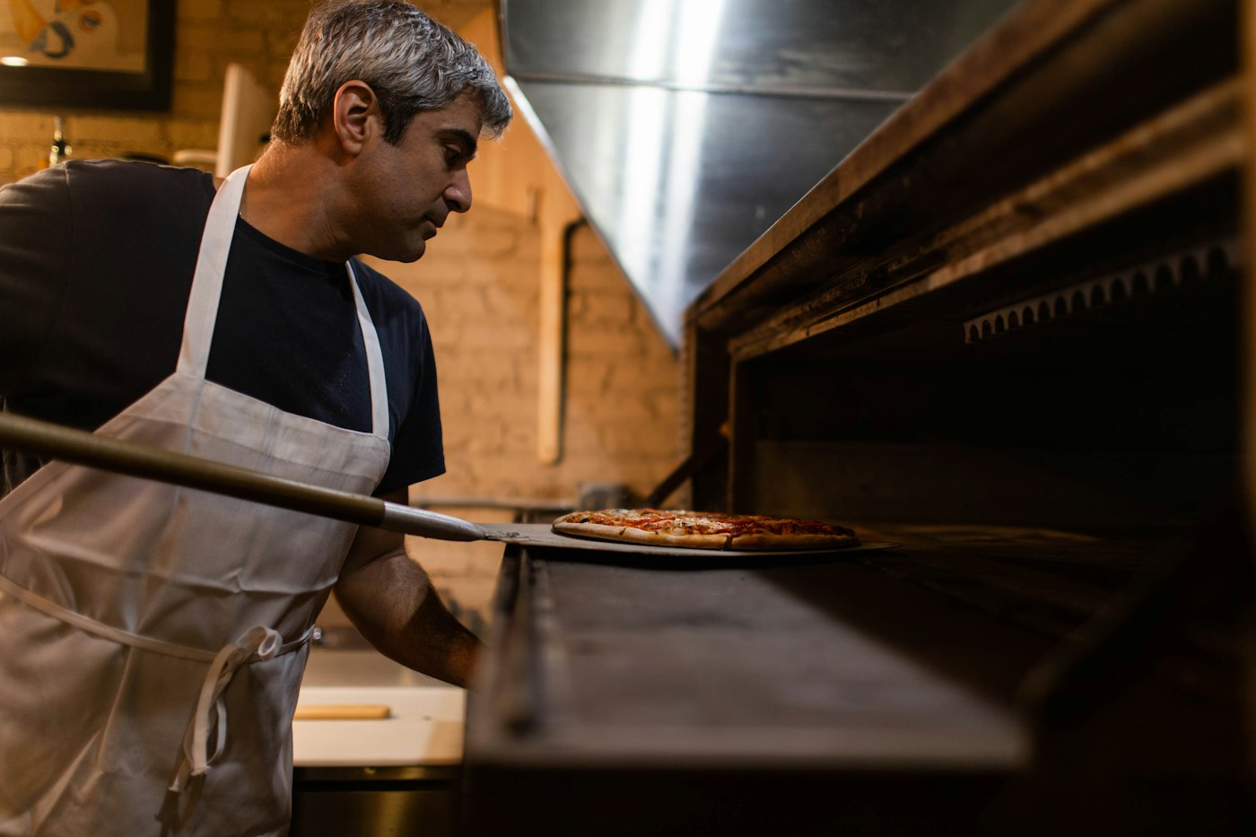 The chef at the wood-fired oven