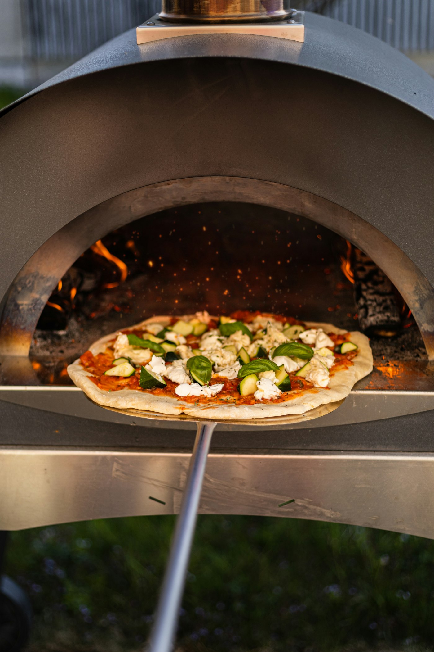 Pizza baking in a wood-fired oven